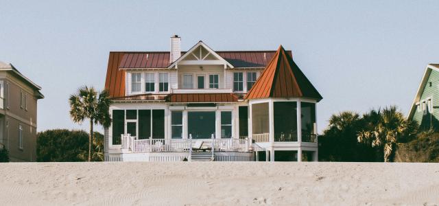 white and brown wooden 2-storey house by Deric courtesy of Unsplash.